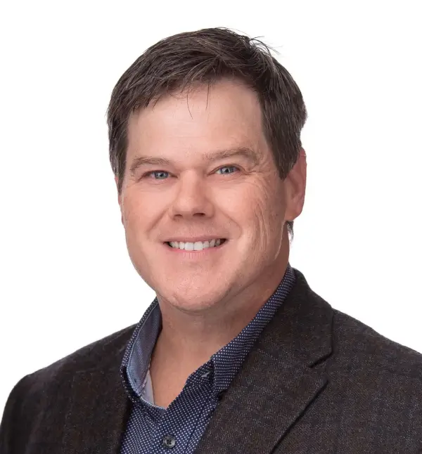 Headshot of smiling man in suit.